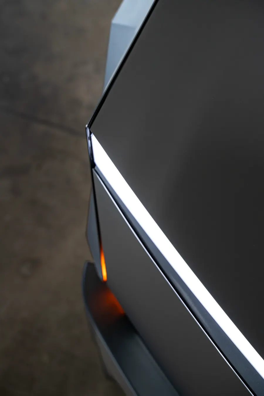 Close-up of a satin Cybertruck front corner at the light bar
