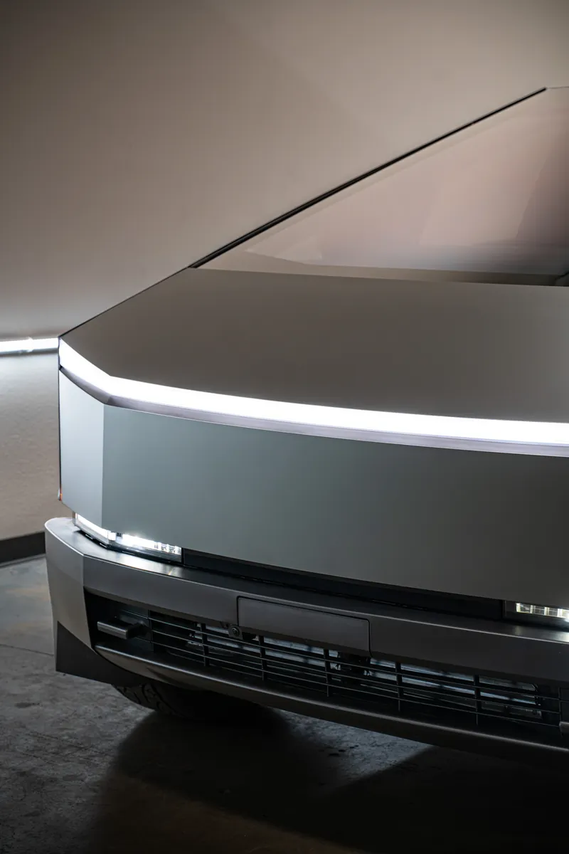 Light bar and front fascia of a grey-olive Tesla Cybertruck