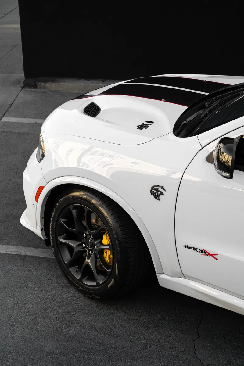Front fender and wheel of a white Dodge Durango SRT with yellow brake caliper