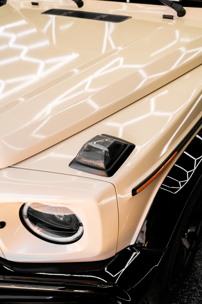 Headlight and hood marker light on a beige Mercedes-AMG G63