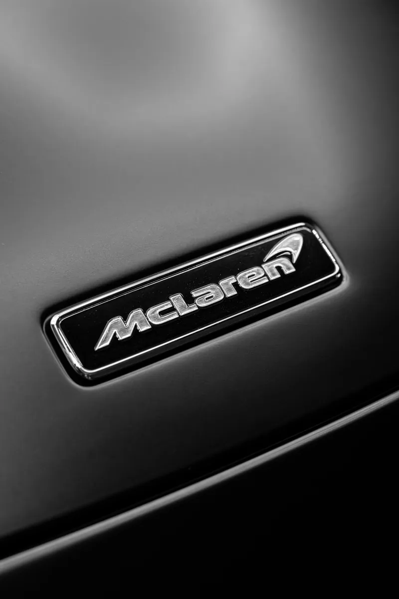 McLaren badge on the satin black hood of a McLaren 720S