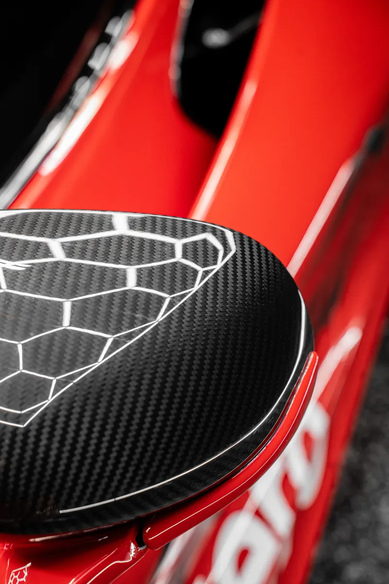 Carbon mirror cap on a red custom wrapped McLaren 720S