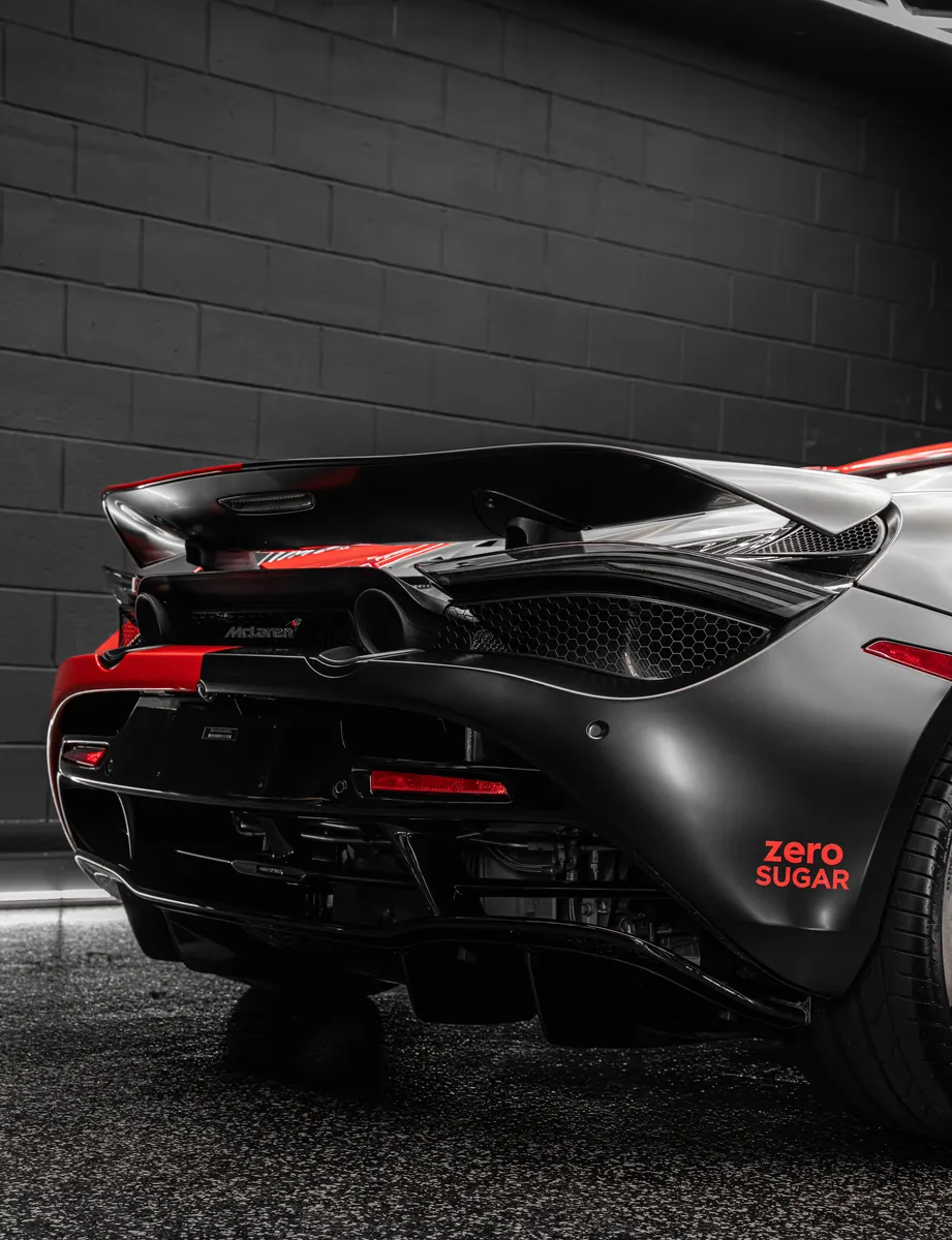 Rear of a McLaren 720S with the wing and a black and red custom livery wrap