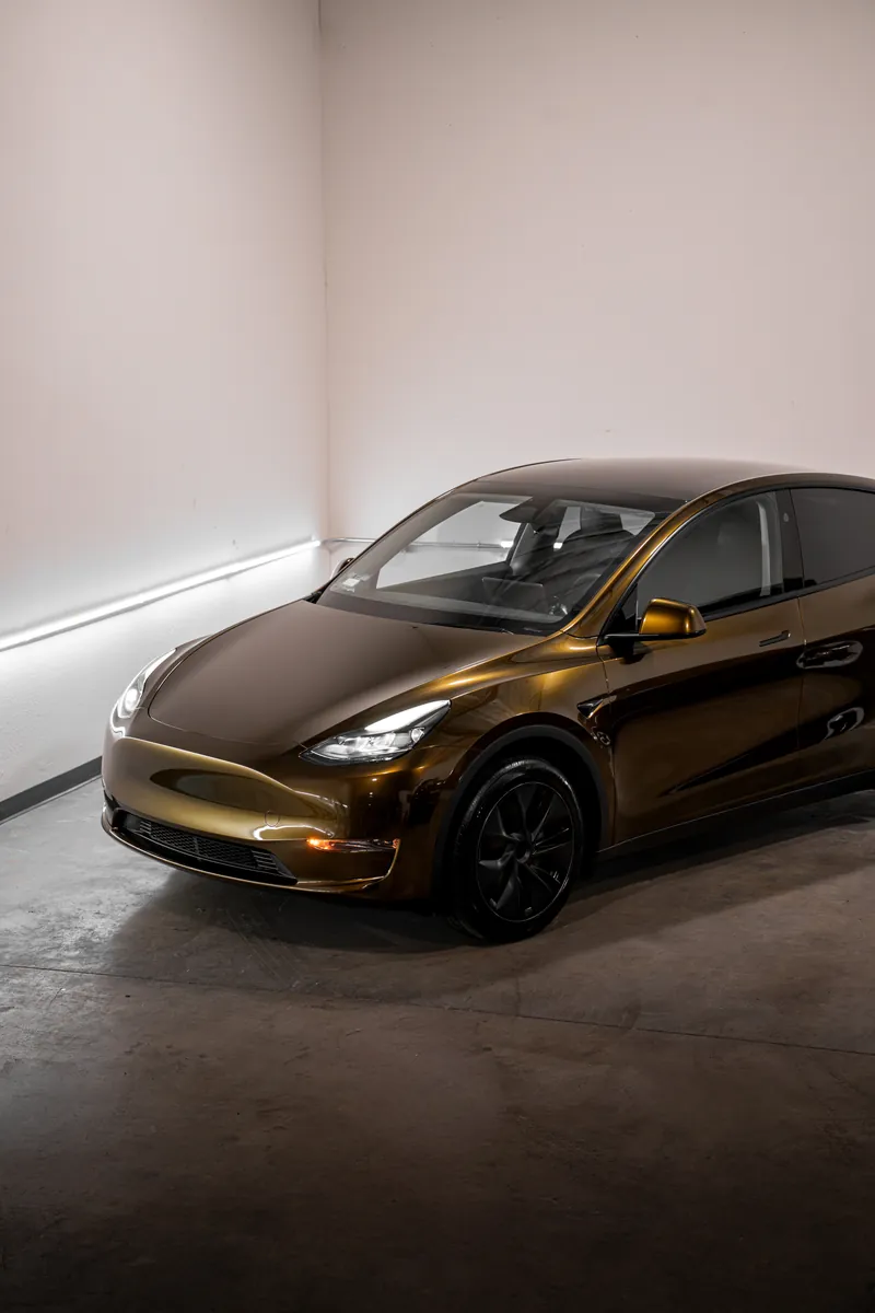 Bronze Tesla Model Y seen from a higher angle in the studio